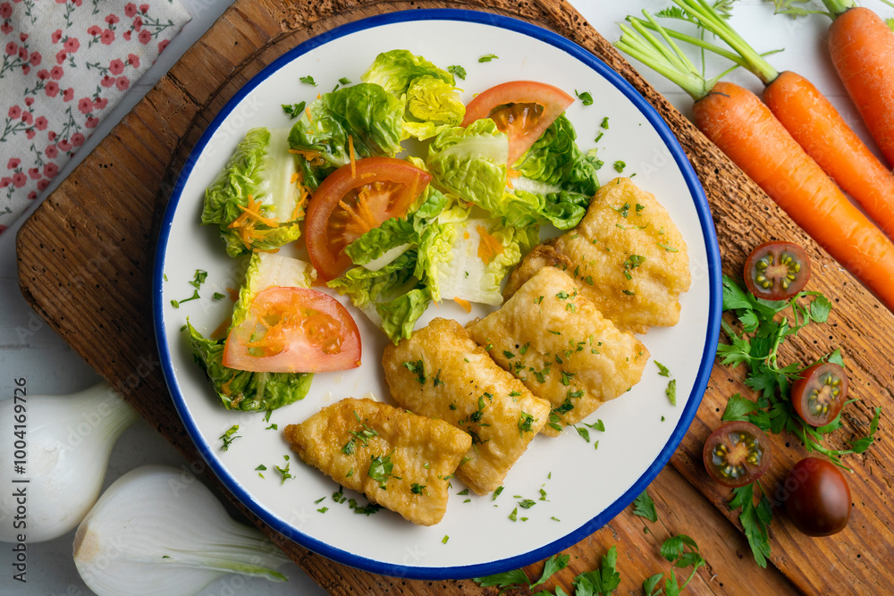 Tempura hake pieces with salad. Top view table with decoration. Tempura hake pieces with salad. Top view table with decoration.