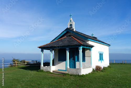 Hermitage of the Regalina with the typical Asturian horreos in Cadavedo, Asturias, Spain photo