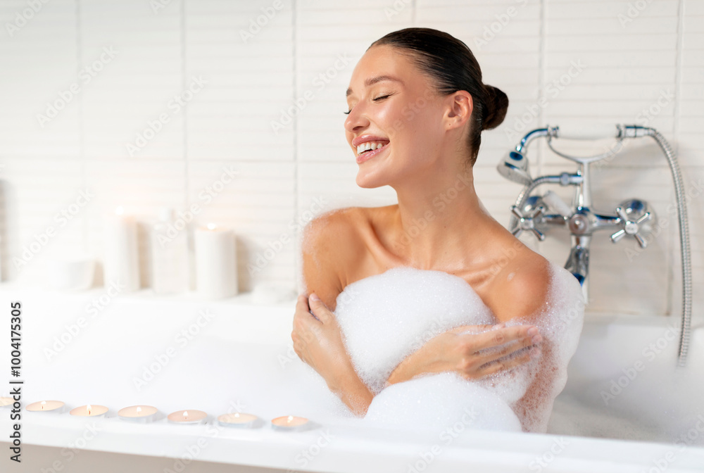 Happy woman taking relaxing bath with foam at home, enjoying warm water in bathroom interior in morning, copy space Happy woman taking relaxing bath with foam at home, enjoying warm water in bathroom interior in morning, copy space