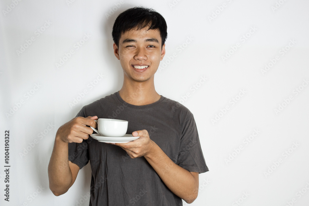 teenager smiling and holding a porcelain cup teenager smiling and holding a porcelain cup
