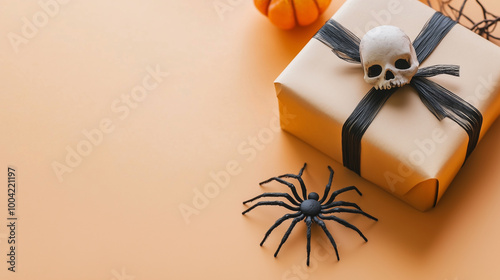 Obraz na płótnie A simple Halloween greeting card template with spider, gift box, and skull arranged neatly on a light orange surface, ideal for copy space w salonie