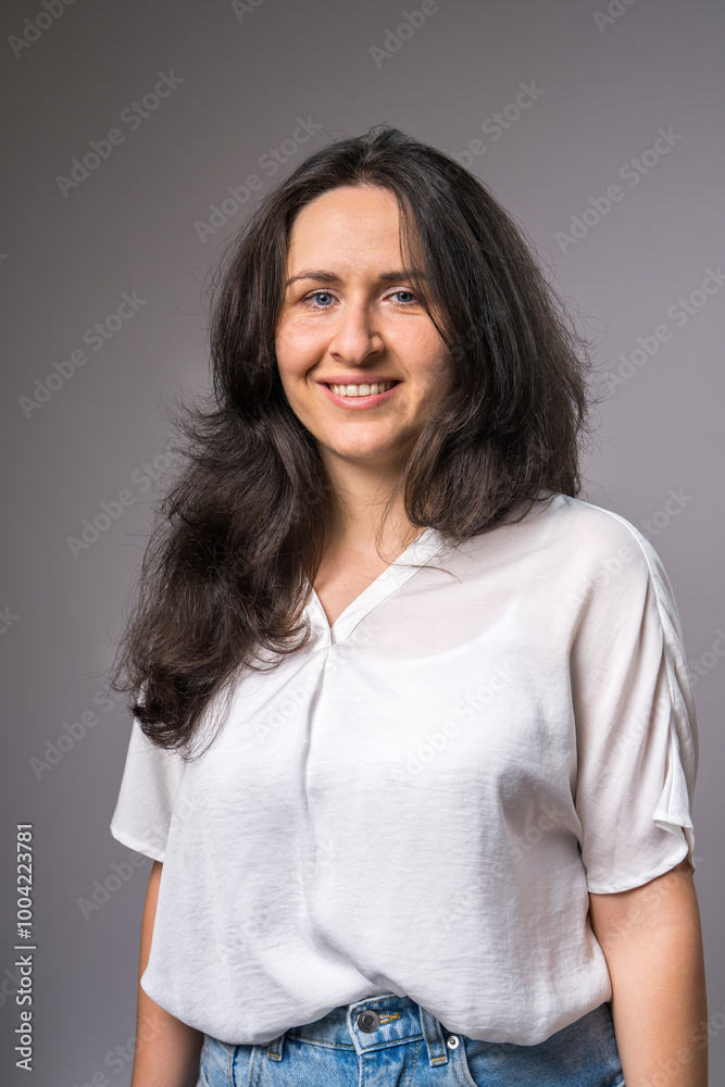 Portrait of beautiful smiling young woman looking at camera, joyful mood. Natural beauty, emotion Portrait of beautiful smiling young woman looking at camera, joyful mood. Natural beauty, emotion