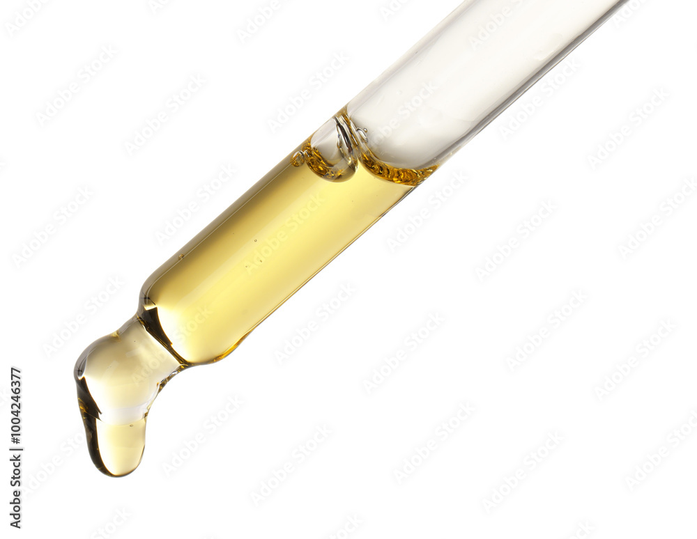 Essential oil dripping from pipette against white background Essential oil dripping from pipette against white background