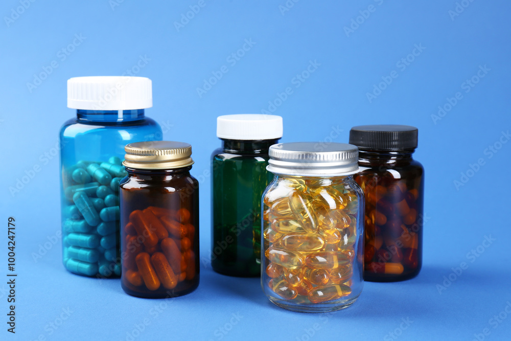 Pharmacist. Different pills in plastic bottles on blue background Pharmacist. Different pills in plastic bottles on blue background
