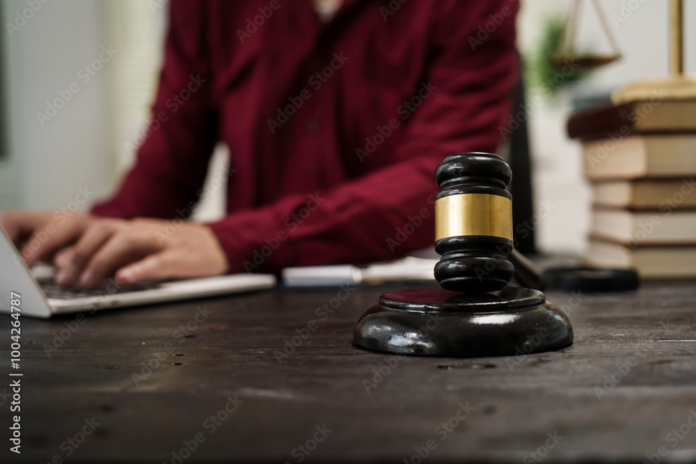 A male lawyer is working at his desk on an online judicial review, focusing on justice, fairness, and legal compliance.He reviews cases, contracts, and legal matters based on general law principles A male lawyer is working at his desk on an online judicial review, focusing on justice, fairness, and legal compliance.He reviews cases, contracts, and legal matters based on general law principles