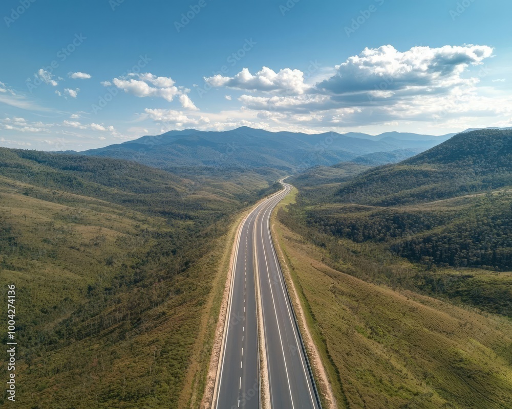 Aerial View of a Majestic Highway Cutting Through a Scenic Mountain Range Aerial View of a Majestic Highway Cutting Through a Scenic Mountain Range