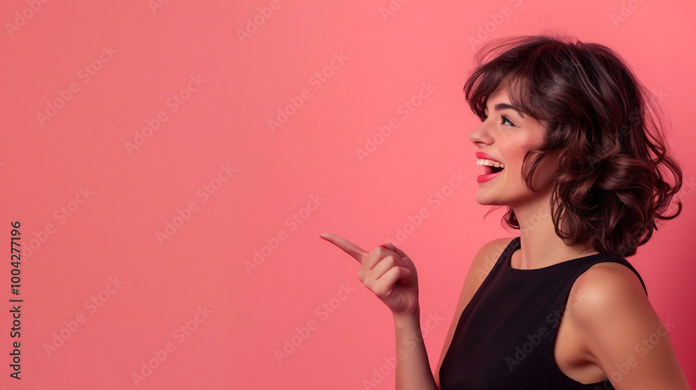 Beautiful girl posing on pink background and pointing finger at place for advertisement and text Beautiful girl posing on pink background and pointing finger at place for advertisement and text