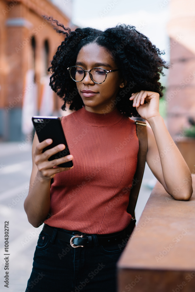 Millennial hipster girl in optical spectacles for vision correction checking notification for smartphone application during ticketing on website and baking operation, attractive woman using phone Millennial hipster girl in optical spectacles for vision correction checking notification for smartphone application during ticketing on website and baking operation, attractive woman using phone