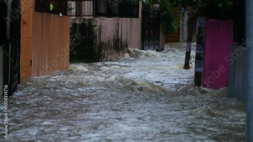 Alleyway flooded because of continuous heavy rainfall, flood water flowing in an alleyway flooding buildings in Kathmandu, Nepal during September monsoon 2024.