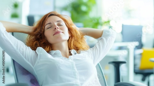 Young businesswoman enjoying a moment of relaxation in her office, stretching her body to alleviate stress and boost productivity during a busy workday.