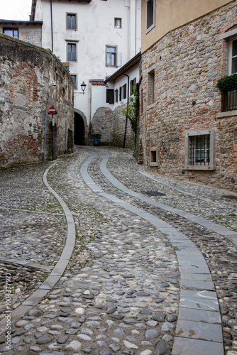 The shapes of a curved cobblestone street in Cividale del Friuli, Friuli Venezia Giulia, Italy