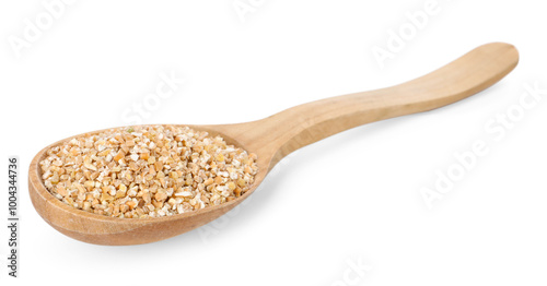 Dry wheat groats in wooden spoon isolated on white