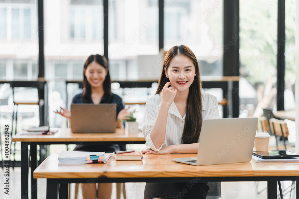 Efficient women working in modern office environment, focused on their laptops. bright space enhances productivity and collaboration, creating positive atmosphere. Efficient women working in modern office environment, focused on their laptops. bright space enhances productivity and collaboration, creating positive atmosphere.