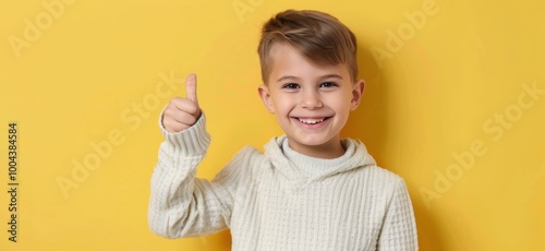 Happy Boy Giving Thumbs Up Against Bright Yellow Background