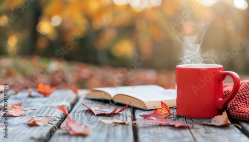 Cozy Red Mug With Steaming Coffee Next to Open Book Among Autumn Leaves