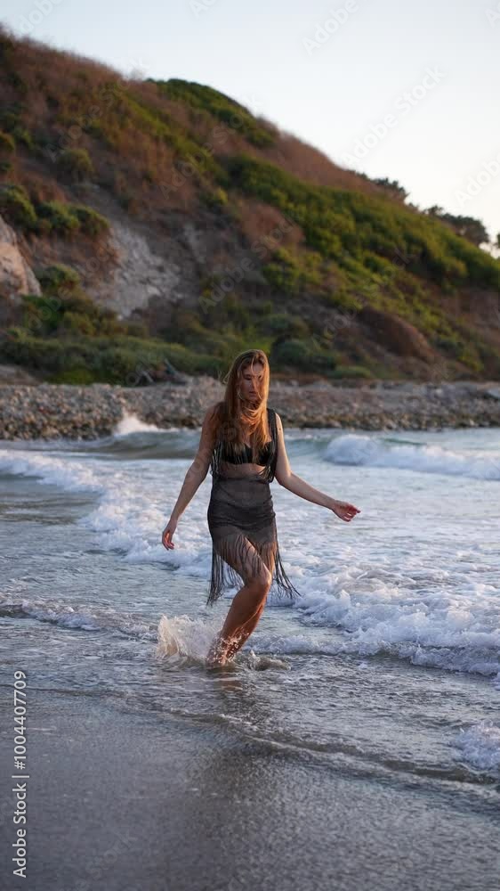 A young European woman poses on the ocean shore, soaking in the sun and the serene atmosphere. This captivating scene embodies the essence of relaxation and the spirit of travel adventures. A young European woman poses on the ocean shore, soaking in the sun and the serene atmosphere. This captivating scene embodies the essence of relaxation and the spirit of travel adventures.