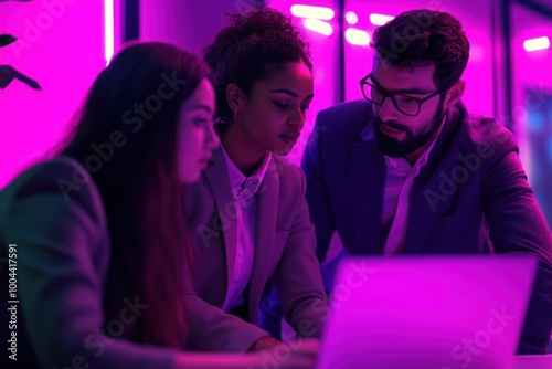 Diverse group collaborating on laptops with purple tint