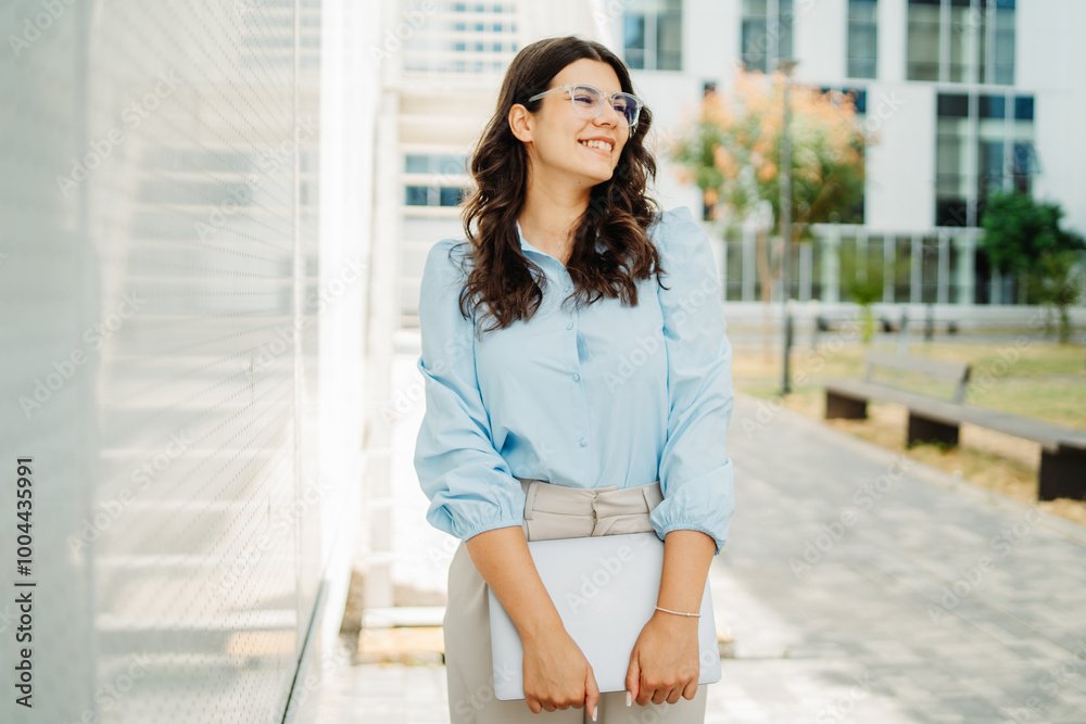 Young successful woman is going to work at modern business building Young successful woman is going to work at modern business building