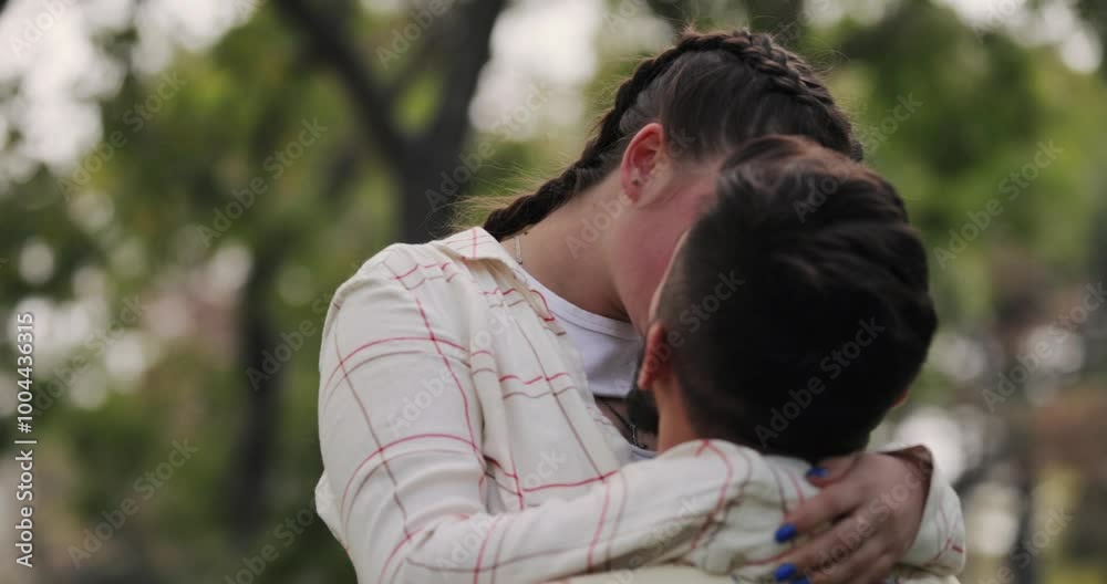 Young couple hugging and kisses in the park, slow motion Young couple hugging and kisses in the park, slow motion