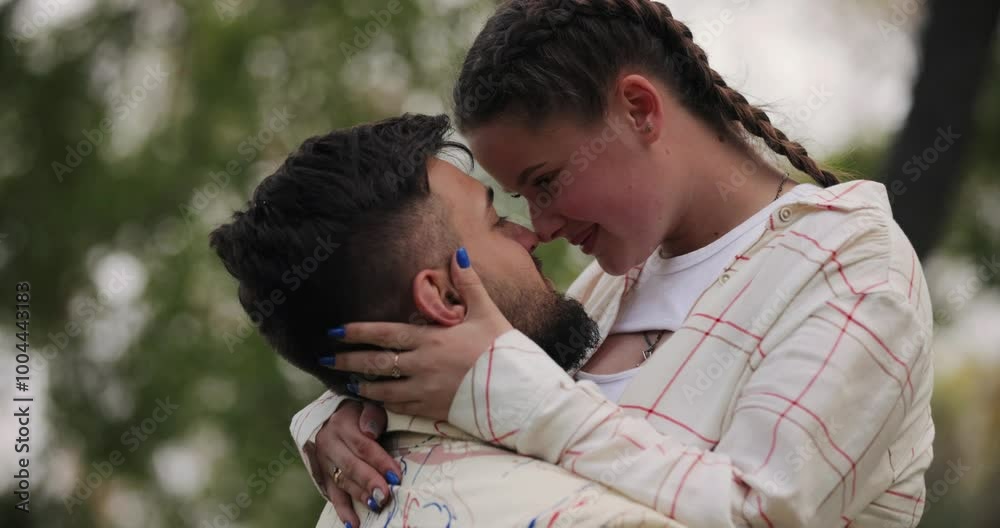 Young couple hugging and kisses in the park, slow motion Young couple hugging and kisses in the park, slow motion