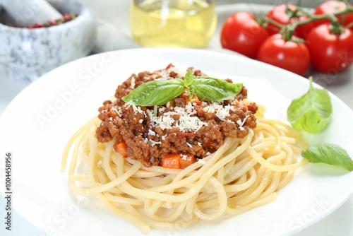 Delicious pasta bolognese with basil on table, closeup