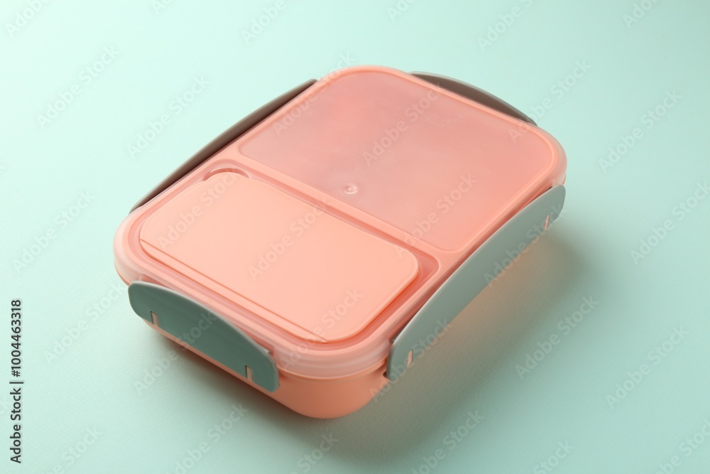 One empty lunch box on light blue background One empty lunch box on light blue background