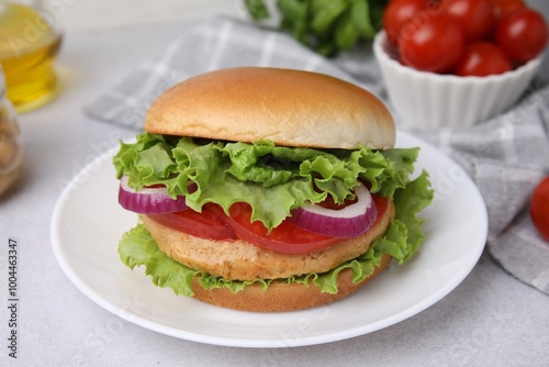 Delicious vegetarian burger with chickpea cutlet on light table, closeup