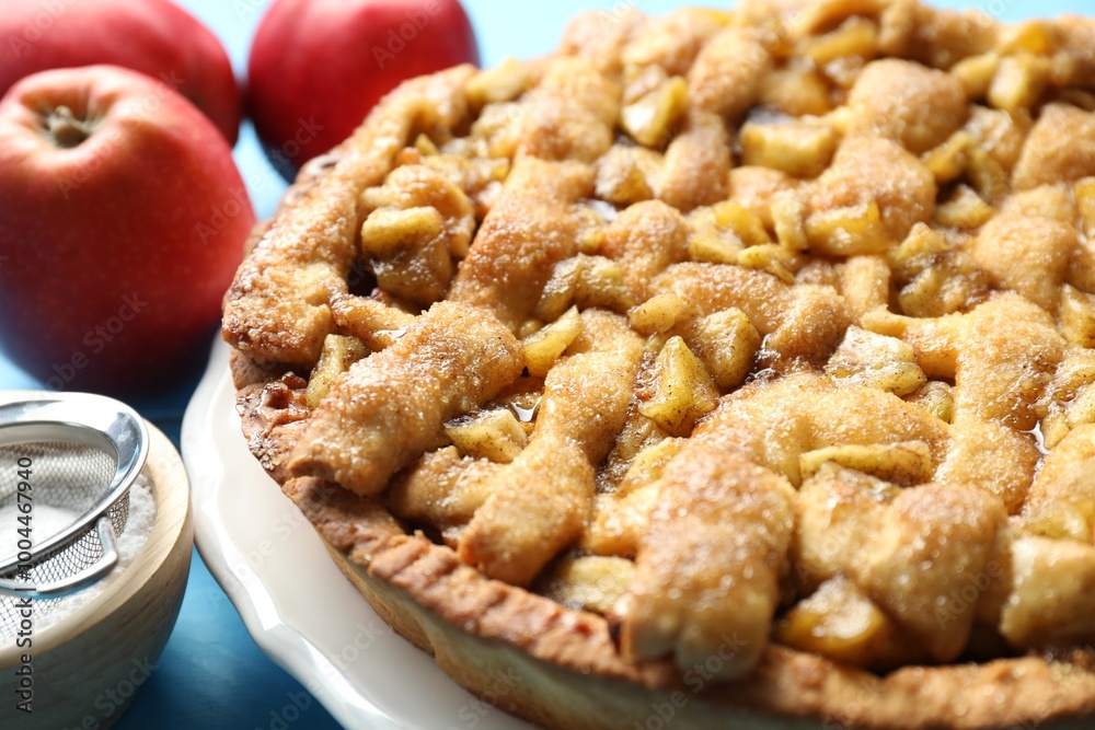 Homemade apple pie and ingredients on light blue wooden table, closeup Homemade apple pie and ingredients on light blue wooden table, closeup