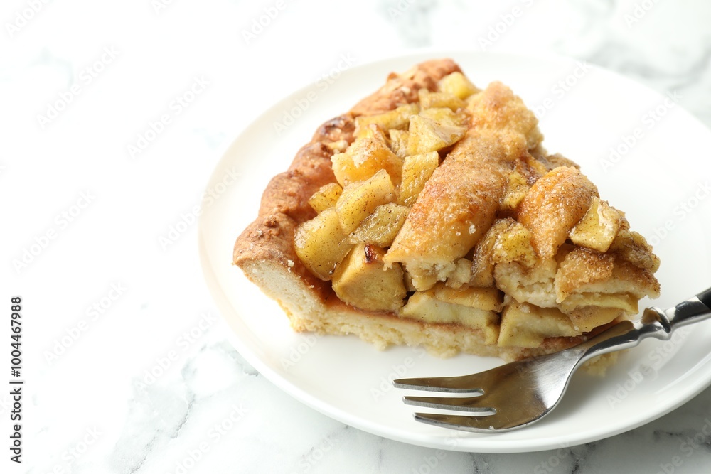 Slice of homemade apple pie and fork on white marble table. Space for text Slice of homemade apple pie and fork on white marble table. Space for text