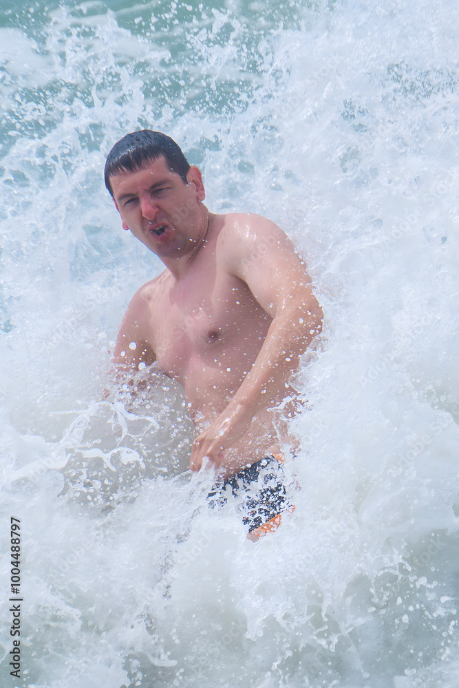 Man 25-30 old swims in a strong storm at sea Man 25-30 old swims in a strong storm at sea