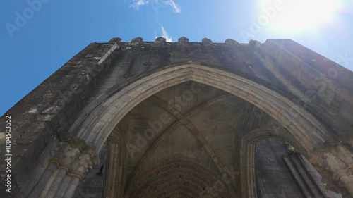 Medieval cathedral in the city of Tui with the sun entering between the towers, Galicia, Spain.