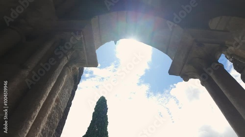 Medieval stone arches through which the sun's rays filter through the city of Tui, Galicia.