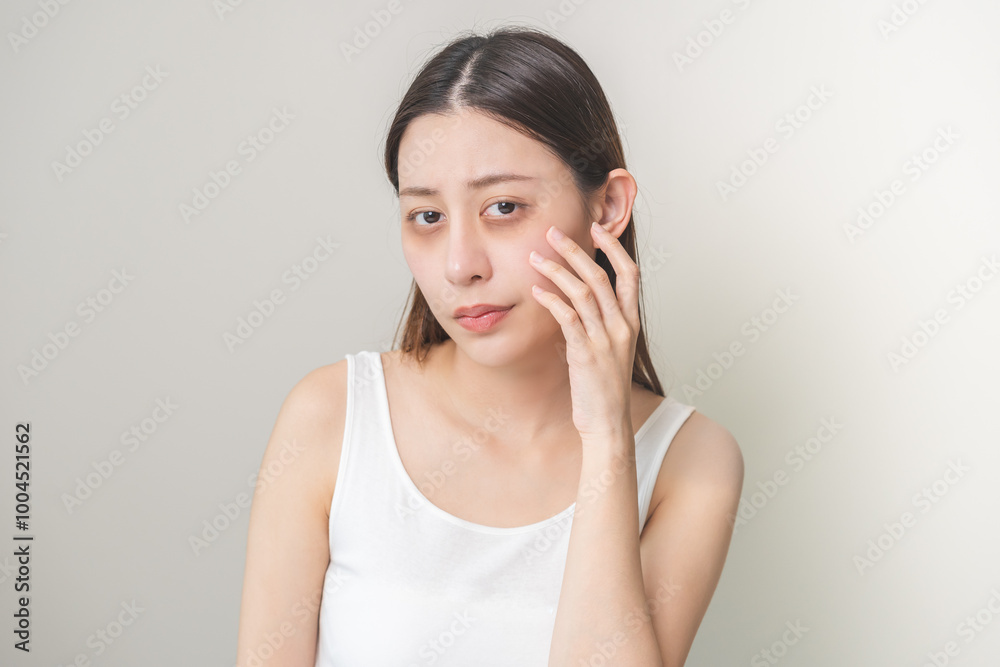 Bored, insomnia asian young woman, girl looking at camera, hand touching under eyes with problem of black circles or panda puffy, swollen and wrinkle on face. Sleepless, sleepy healthcare person. Bored, insomnia asian young woman, girl looking at camera, hand touching under eyes with problem of black circles or panda puffy, swollen and wrinkle on face. Sleepless, sleepy healthcare person.