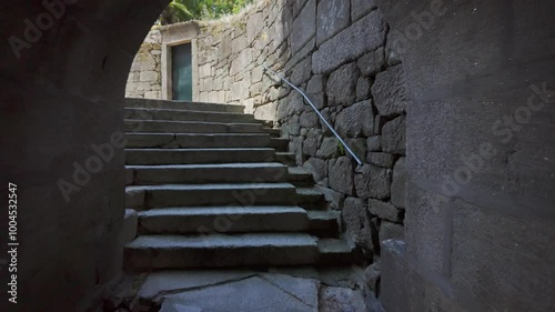 Stone tunnel giving access to narrow alleys in the medieval town of Tui, Pontevedra.