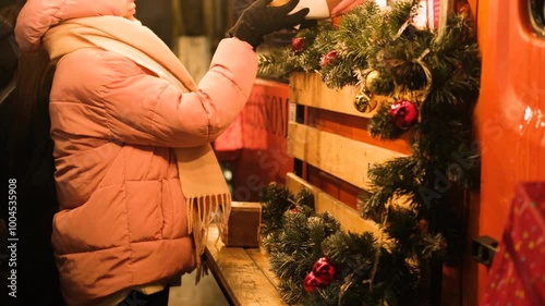 A young woman picks up her order from a food truck at a Christmas food court