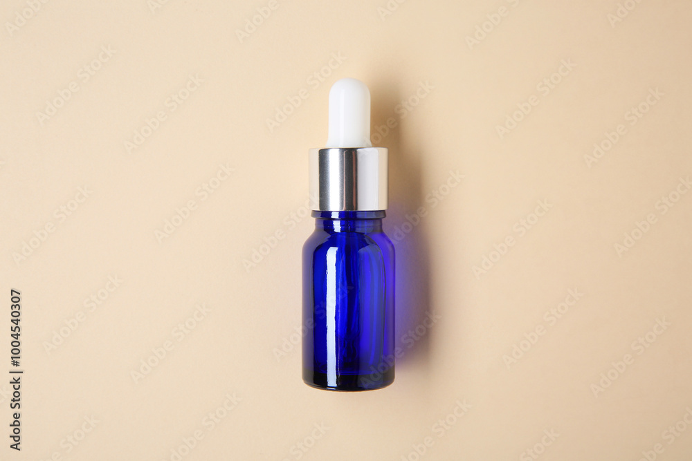 Essential oils in bottle on beige background, top view Essential oils in bottle on beige background, top view