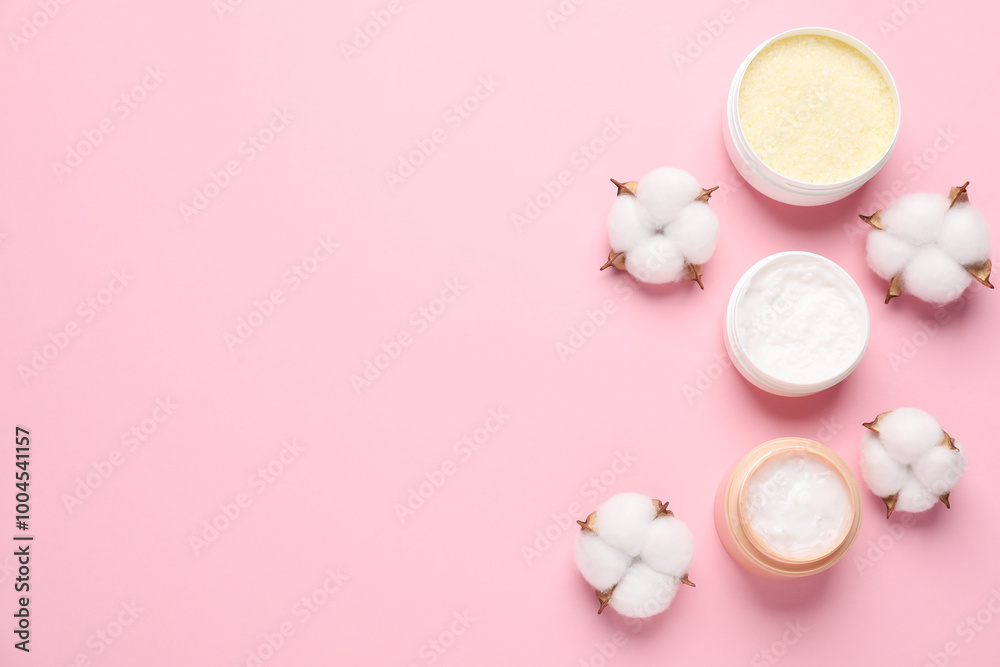Different cosmetic products and cotton flowers on pink background, flat lay. Space for text Different cosmetic products and cotton flowers on pink background, flat lay. Space for text
