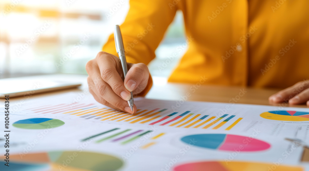 A consultant's hand turning the pages of a project analysis report during a client meeting, project analysis review, business consulting. A consultant's hand turning the pages of a project analysis report during a client meeting, project analysis review, business consulting.