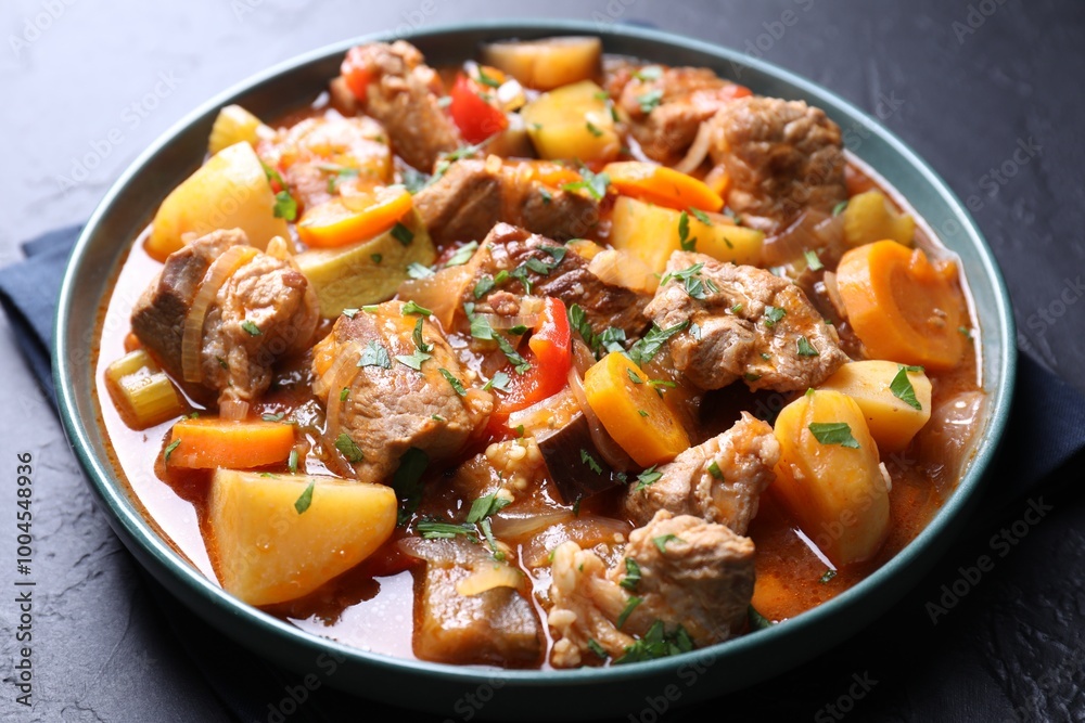 Delicious stew with vegetables on black table, closeup Delicious stew with vegetables on black table, closeup