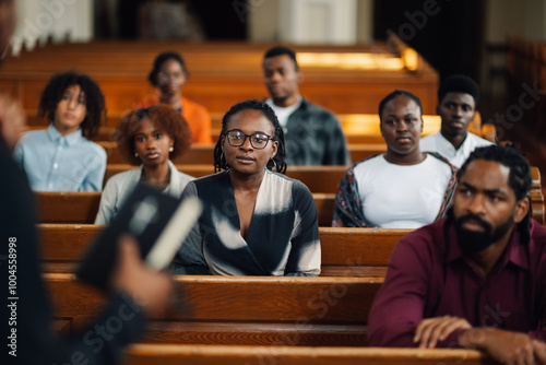 Canvas Print Group of people sitting in church pews listening to sermon