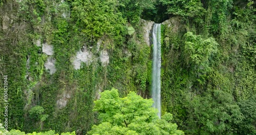 Katibawasan Falls surrounded by mountain and green forest. Camiguin Island. Philippines. photo