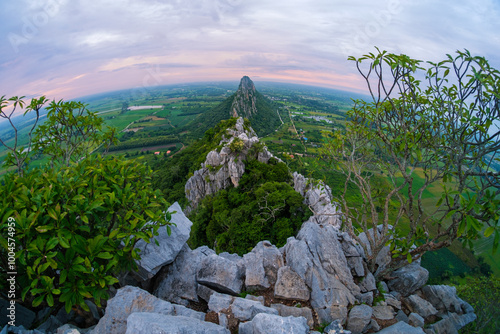 A mountain range with a lush green forest and a clear blue sky Khao Nor - Khao Kheaw , Nakornsawan, thailand photo