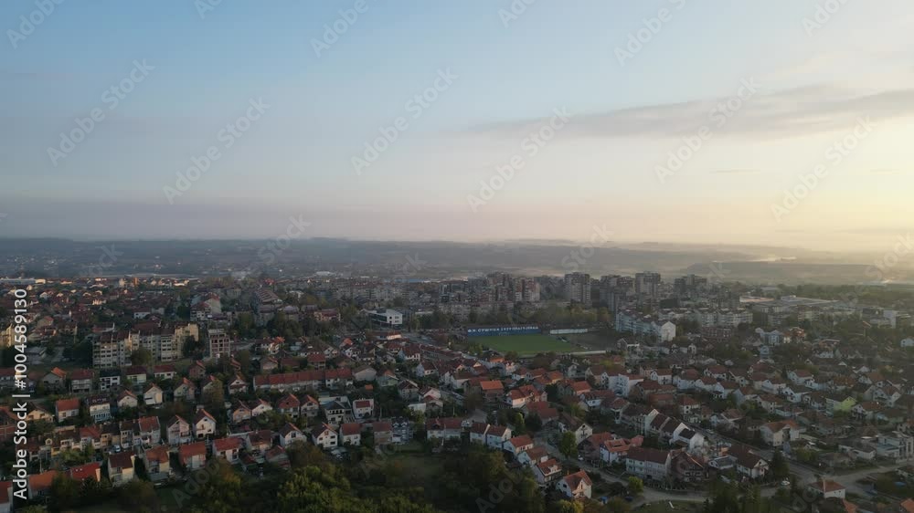 Drone video of sunrise above small town with color sky Drone video of sunrise above small town with color sky