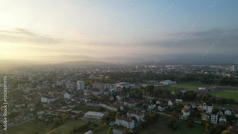 Drone video of sunrise above small town with color sky Drone video of sunrise above small town with color sky