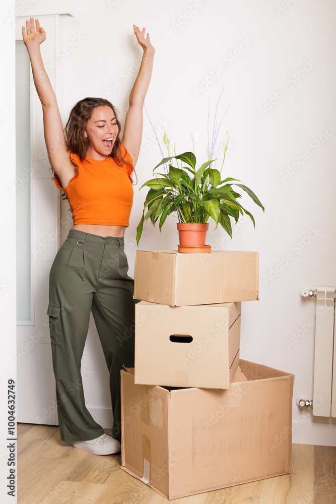 Young woman very happy to have bought her own house. A flat just for her. She is a homeowner, happily single. Fulfilling a dream. A new stage. Beginnings, new house, new life. Time to pay the mortgage Young woman very happy to have bought her own house. A flat just for her. She is a homeowner, happily single. Fulfilling a dream. A new stage. Beginnings, new house, new life. Time to pay the mortgage