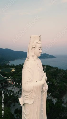 Lady Buddha at Sunset - Epic Aerial Done View of this incredible temple in the hills of Da Nang, Vietnam - Tourism Feature for Worldwide Tourists - Vertical Video