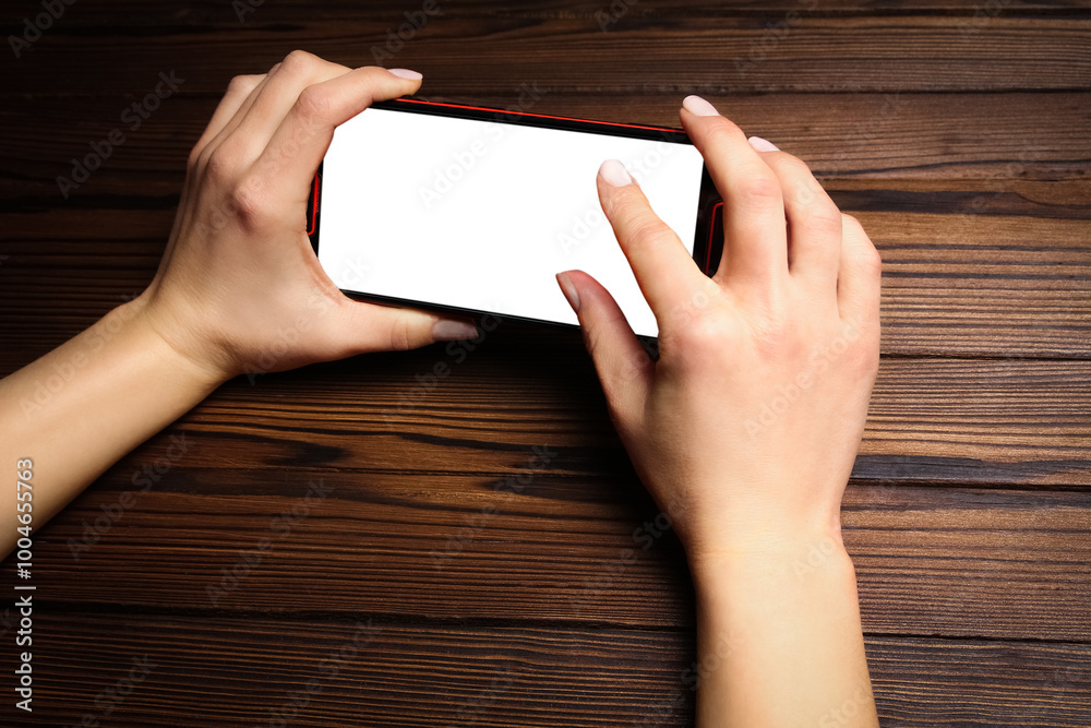 a phone with hands addiction on a wooden background a phone with hands addiction on a wooden background