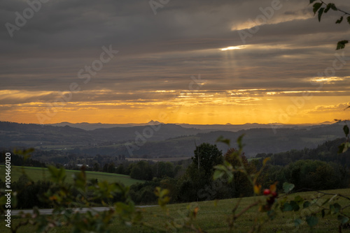 Autumn orange sunset with trees and fields near Roprachtice village in mountains