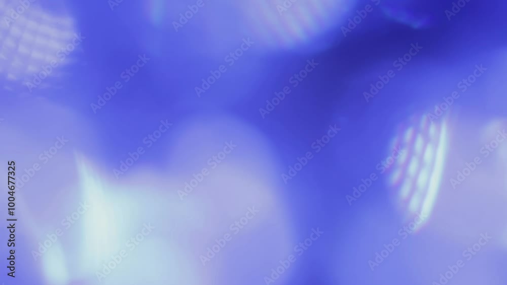 Light hitting a crystal glass creates different flashes of light on the camera lens, flowing across the screen as it shines