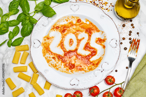 Fototapeta Naklejka Na Ścianę i Meble -  Celebratory plate of pasta with tomato sauce featuring the year 2025, surrounded by fresh ingredients in a colorful kitchen setting